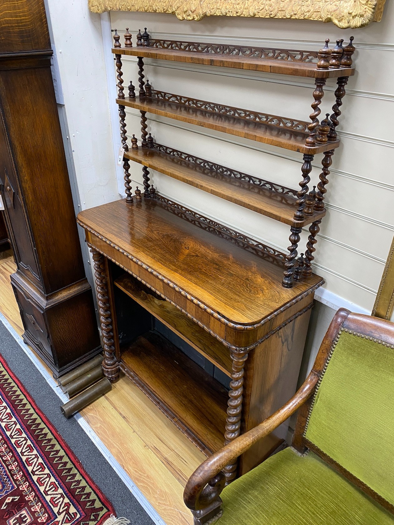 An early Victorian rosewood open bookcase with spiral turned fretwork superstructure, width 92cm, depth 36cm, height 156cm